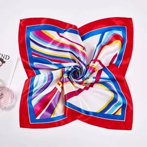 Detailed view of a square silk scarf with red border and vibrant striped pattern