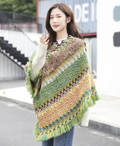 Bohemian style knitted pullover poncho with colorful zigzag pattern and fringe tassel details