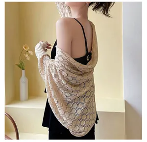 Back view of a beige honeycomb knit hollow-out shawl with sleeve cuffs