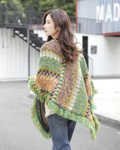 Detailed back view of a bohemian knitted poncho with ethnic zigzag patterns and fringe trim