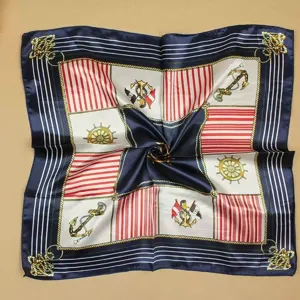 Detailed macro view of professional nautical silk scarf with anchor and helm patterns