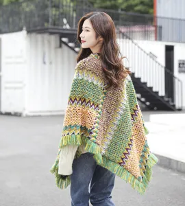 Detailed back view of multi-colored ethnic style knitted poncho with long fringe tassels