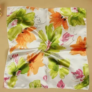 Elegant square silk scarf with vibrant green and orange floral print for professional wear.