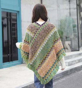 Detailed back view of the ethnic knitted poncho featuring vibrant zigzag patterns and fringe