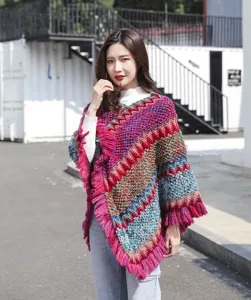 Full view of women's bohemian knit poncho with colorful zigzag patterns and fringe