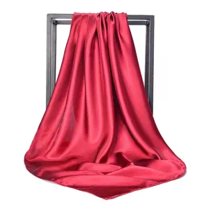 Detailed close-up view of a solid red satin square scarf with an elegant glossy silk finish