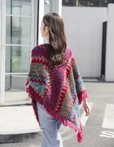 Back view of a bohemian knit poncho with colorful patterns and vibrant fringe detail.