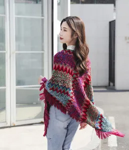 Close-up detail of colorful ethnic knitted shawl with fringe tassels for winter