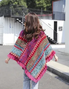 Rear view of ethnic style knitted poncho featuring colorful chevron pattern and long tassels