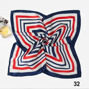 Top-down detail of professional silk scarf with red and navy blue geometric stripes