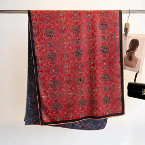 Detail view of reversible mulberry silk scarf with traditional patterns and hand-rolled edges