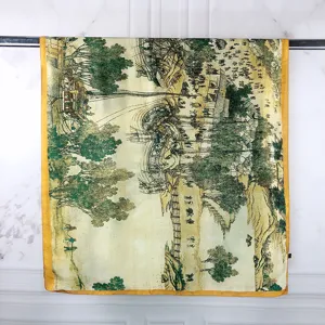 Detail showing the traditional Chinese landscape painting on a yellow-bordered scarf.