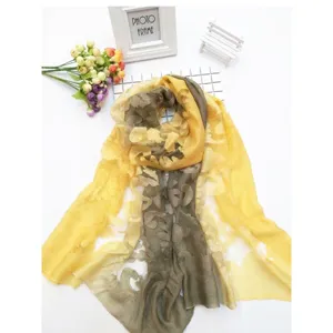 Detail of yellow and grey tie-dye long scarf with elegant lace cutout floral patterns