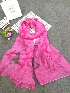 Detailed view of pink sheer scarf with elegant cut-flower patterns and textures
