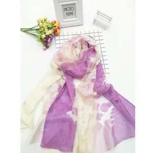 Macro view of purple and white tie-dye lace scarf featuring hollowed out floral details