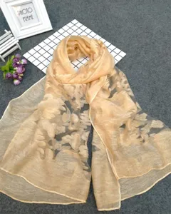 Detailed view of champagne burnout floral scarf with semi-transparent fabric texture