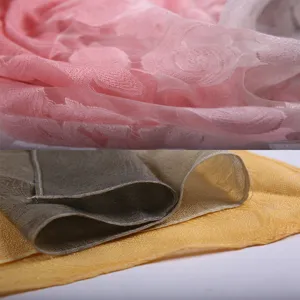 Close-up showing the intricate rose pattern and semi-transparent texture of the scarf.