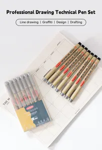 Detail shot of a 7-piece professional black fineliner pen set on a planner