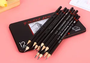 Detailed view of professional sketching pencils over a black metal storage tin case
