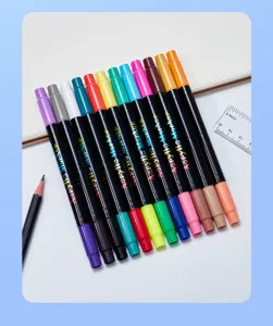 Detailed view of vibrant double-ended acrylic markers neatly arranged on a white sketchbook