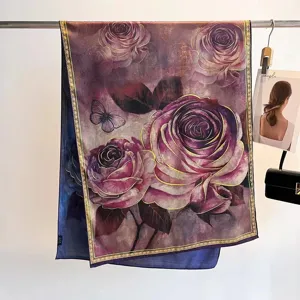 Detailed view of luxury floral silk scarf featuring elegant rose print and hand-rolled edges