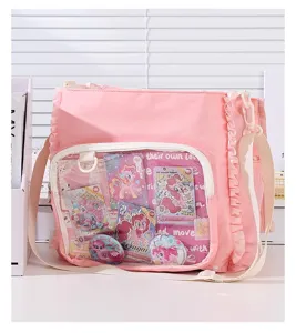 Detailed view of pink ruffle ita bag featuring a transparent pocket for merchandise