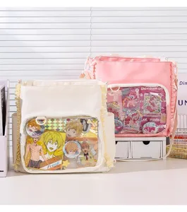 Detail view of the lace trim and transparent window of a pink and white ita bag.