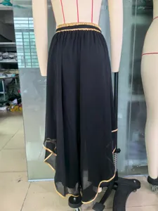 Detail back view of high-waist black chiffon wide-leg pants with gold piping decoration.
