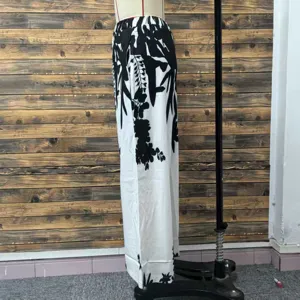 Detailed side view of black and white floral print wide-leg casual trousers for women