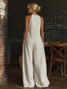 Back view of elegant white lace-trimmed loose sleeveless wide-leg jumpsuit