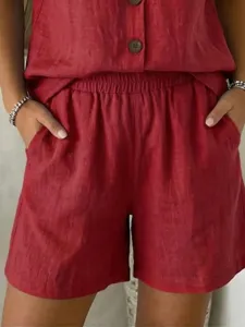 Close-up of red cotton linen shorts featuring elastic waist and side pockets