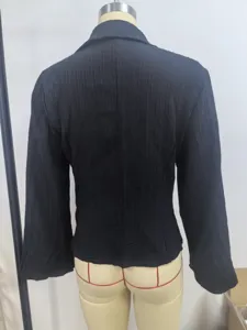 Back view of elegant black textured long-sleeved shirt showing ribbed fabric detail