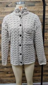 Macro view showing the detailed cable-knit texture and buttons of this retro gray cardigan