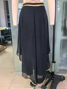 Detailed shot of black high-waisted chiffon wide-leg pants with elegant gold piping