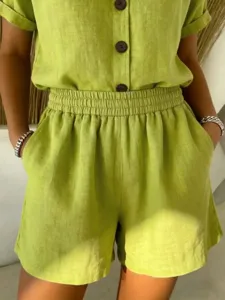 Detailed view of women's lime green cotton linen shorts featuring elastic waist and pockets