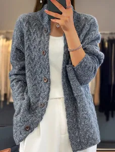 Close-up of vintage gray cable-knit cardigan with stand collar and button details