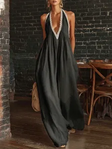 Detail of black lace-edged halter neck jumpsuit with loose-fit elegant silhouette
