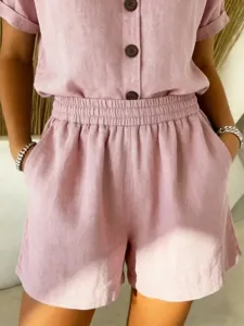 Close-up detail of a pink linen cotton casual shorts and button-up shirt set for women