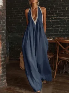 Elegant deep V-neckline detail with delicate cream lace trim on a loose blue jumpsuit