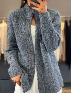 Close-up of grey vintage cable knit cardigan featuring a stand collar and brown buttons