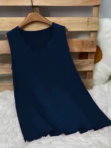 Detail of a navy blue sleeveless tank top with a stylish scalloped V-neckline.
