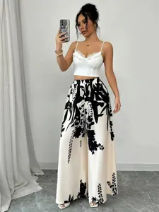 Elegant women's high waisted wide leg trousers featuring chic black and white floral prints