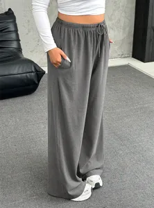 Close-up of women's grey wide-leg lounge pants with drawstring waist and pockets