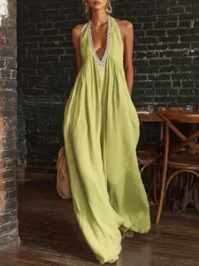 Elegant lime green halter-neck wide-leg jumpsuit with delicate lace trim detail.