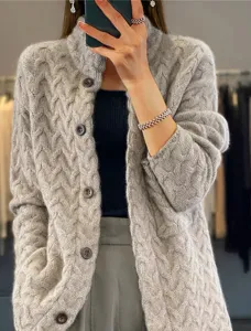 Detailed close-up view of a vintage grey cable-knit cardigan with a stand collar.