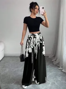 Women's chic black crop top and floral print wide-leg trousers outfit