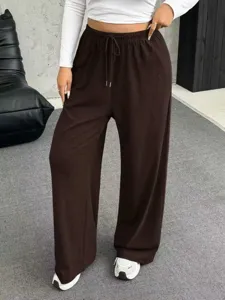 Detail view of brown wide-leg drawstring pants for women with comfortable fit.