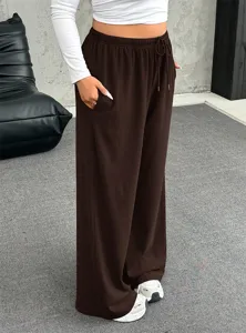 Detailed view of brown wide-leg lounge pants featuring a functional drawstring waist