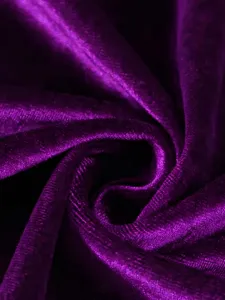 Detailed macro shot of purple velvet fabric texture showing soft pleats and luxury sheen