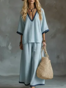 Relaxed women's summer two-piece set with light blue V-neck top and matching wide-leg pants